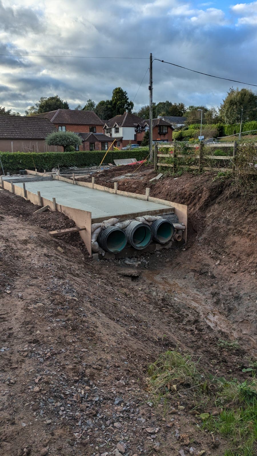 Culvert construction showing three drainage pipes