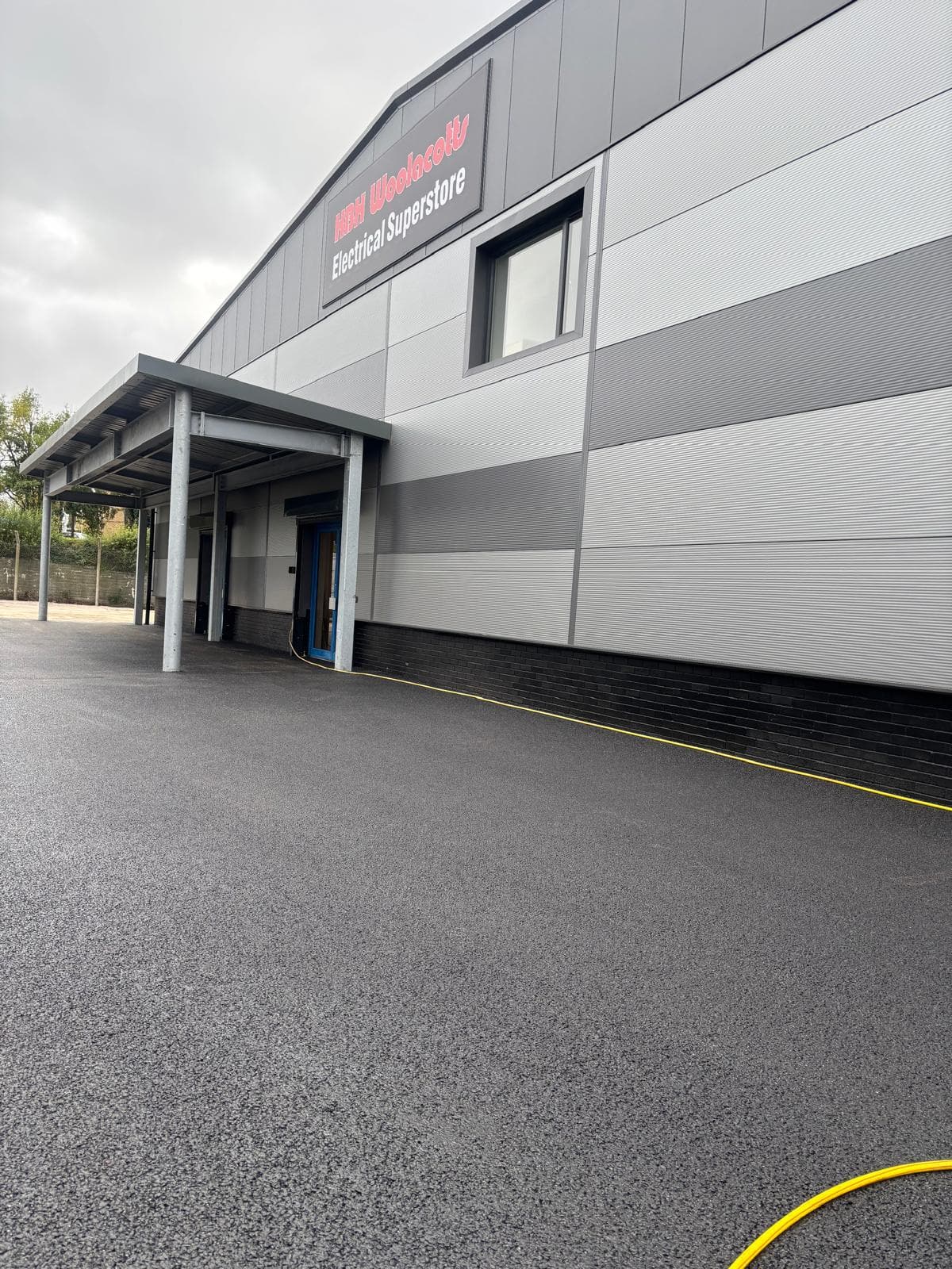 Industrial tarmac entrance yellow line marking Devon